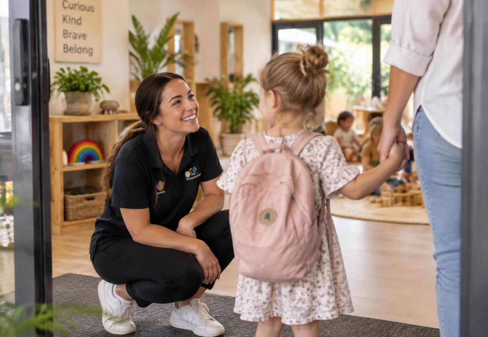 Educator welcoming a parent and child at an Australian early learning centre